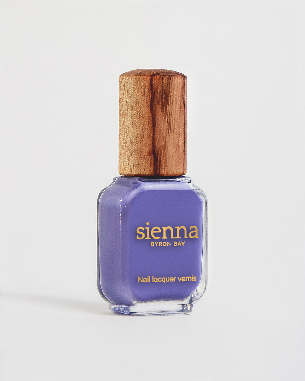 Gentle midtone blue lilac creme Sienna nail polish bottle with timber cap